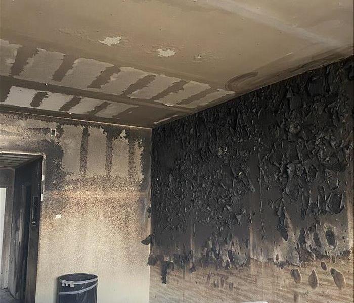 Badly burned room with black charred walls.
